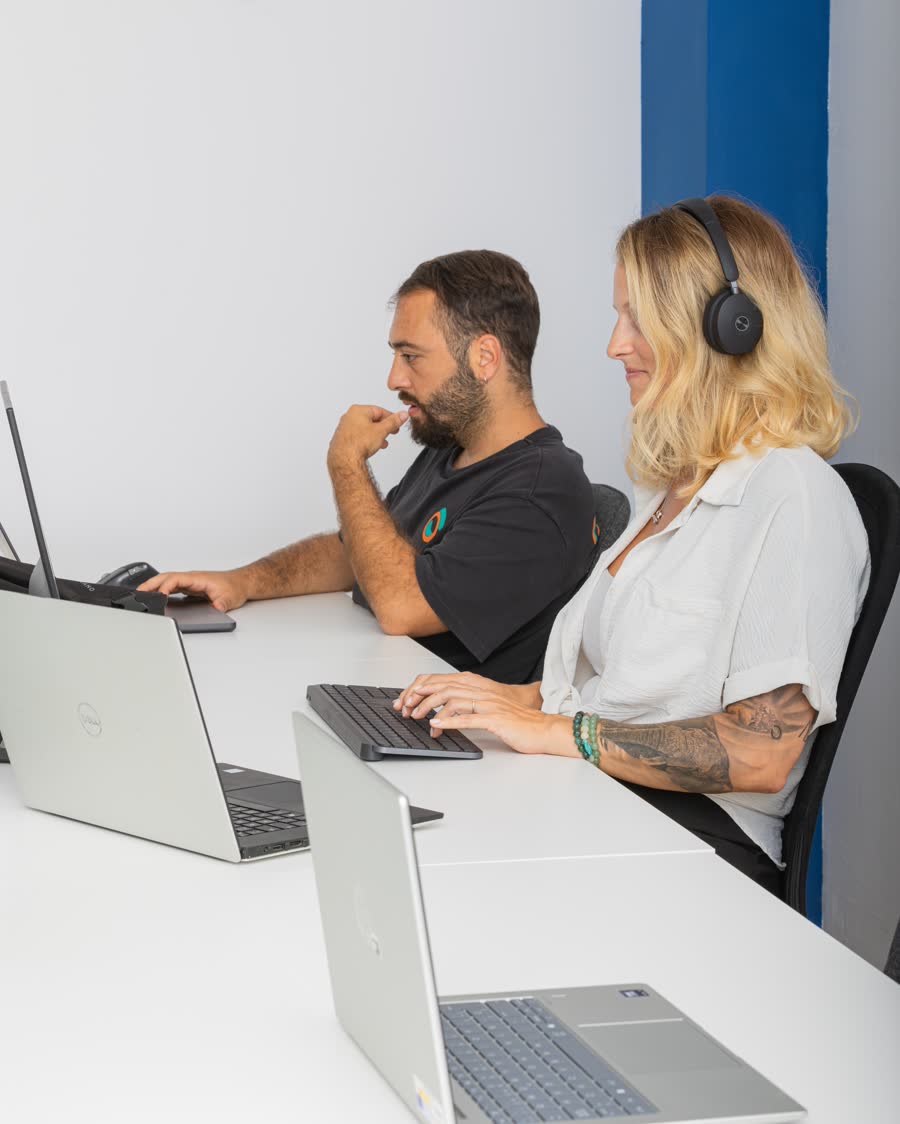 Two members working side by side at their laptops